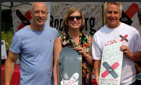 Members of the Ethan Zakes Foundation holding two of Ethan's skateboards