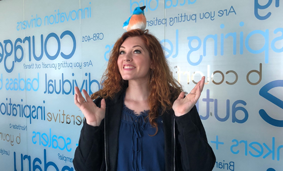 America’s Got Talent contestant, Mandy Harvey, in the bluebird bio offices with a plush bird stuffed animal on her head